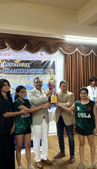 SICSR students and faculty with a championship trophy